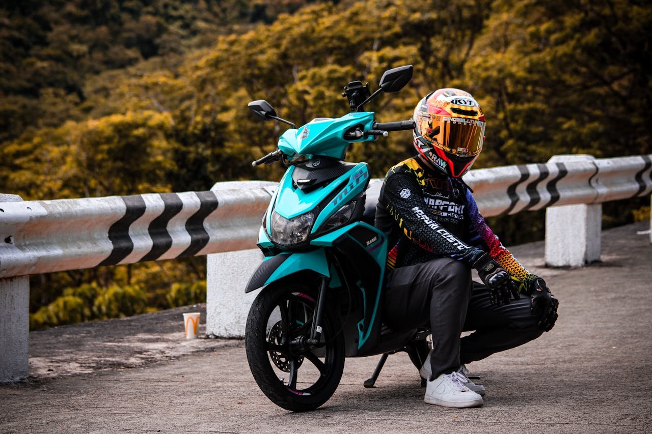 A person sitting on a motorcycle on a road